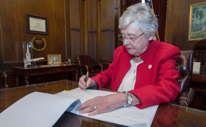 Губернатор штата Алабама Кей Айви подписывает новый закон